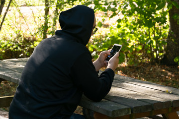 BOY LOOKING AT THE SMARTPHONE