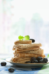 gluten free homemade pancakes plate with blueberry and top mint leaf breakfast on white kitchen table snow winter window background copy space