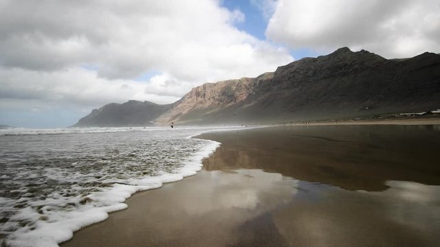 Reflecting beach on the Canary Islands. Rocks on the beach in Lanzarote.