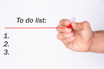 To do list. Hand holding a red marker. White background. Copy space