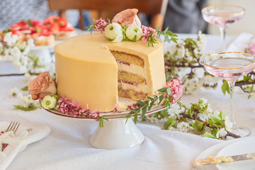 Festive wedding cake with flowers, boho style table setting