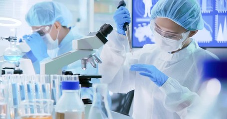 Asian scientist take petri dish - Powered by Adobe