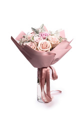 beautiful bouquet of red roses in pastel pink packaging isolated on white