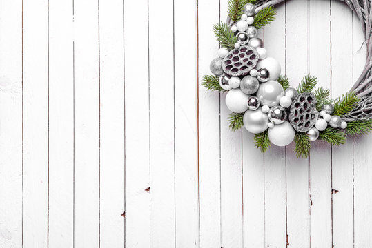 Christmas Wreath On Wooden Background With Silver Baubles And Christmas Tree Branches