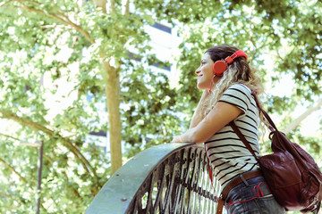 Young woman listening to music with headphones.