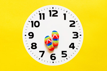Vacation background. Time to have a rest, time of vacation. Bright flip flops in the form of arrows...