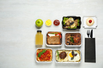 Fototapeta na wymiar Lunchboxes on white wooden table, flat lay. Healthy food delivery