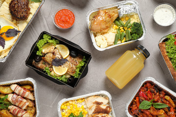 Lunchboxes on grey table, flat lay. Healthy food delivery