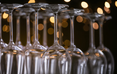 Empty glasses against blurred lights, closeup view