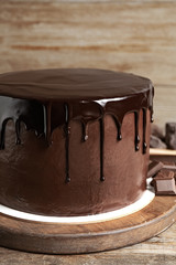 Freshly made delicious chocolate cake on wooden table