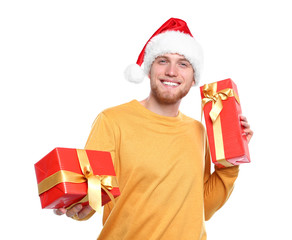 Young man with Christmas gifts on white background