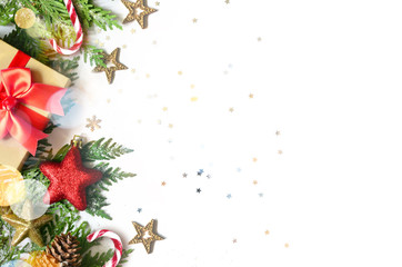 Christmas background, green pine branches, cones and gift box on white background. Creative composition with copy space, top view. New Year's holiday, christmas.