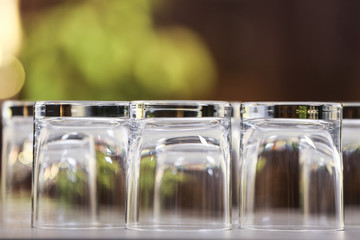 Set of empty glasses on grey table against blurred background