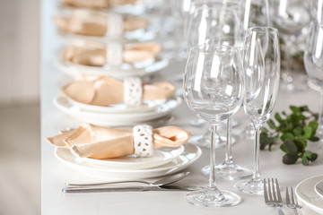 Table setting with empty glasses, plates and cutlery indoors