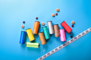 Sewing kit: scissors, measuring tape, thimbles, threads and buttons. Composition with threads and...
