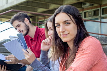 Group of  University students studying together outdoors