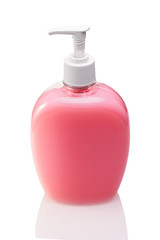 Pink bottle of liquid soap or gel with a pump on a white isolated background close-up.