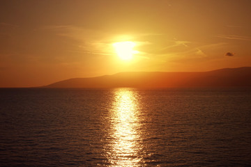 Photo of beautiful cloudy sunset with golden colours over the Aegean sea