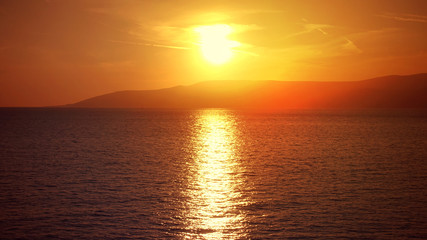 Photo of beautiful cloudy sunset with golden colours over the Aegean sea