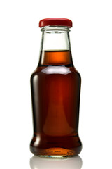 Brown bottle of juice or syrup on a white isolated background close-up.