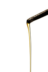 Pouring oil from an oil can. Close-up of a drop drop of oil from an old oilcan on a white isolated background.