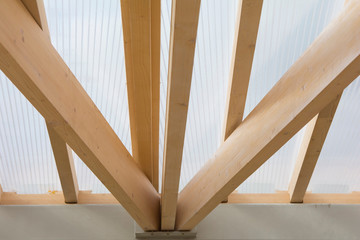 transparent roof of the gazebo on wooden timber supports