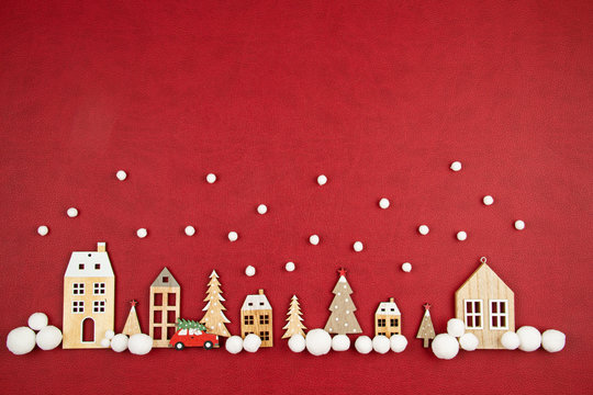 Christmas composition with toy  wooden houses over the red background
