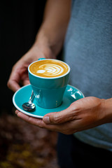 Closeup of hands with coffee cups in a cafe