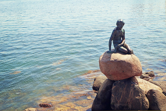 COPENHAGEN, DENMARK -The Little Mermaid statue from 1913 at the entrance of Copenhagen harbor, inspired by the Christian Andersen fairy tale,  symbol of the Danish capital.