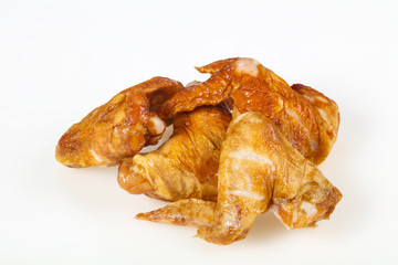 Smoked chicken wings over white background