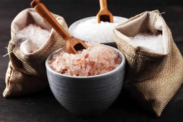 Sea salt and himalayan in burlap. Crystals of salt on dark background