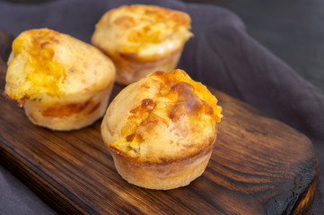 homemade cheese muffins on a dark background.