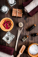 spa cosmetics with soap, salt, oil on white background top view