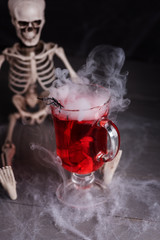 Halloween cocktail Red-Handed-Jill with skeleton and smoke