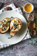Selective focus. Baked pears with dor blue cheese on a plate. Healthy lunch. Keto diet. Keto snack.