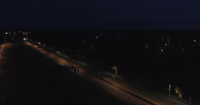 An amazing aerial view of Kohtla-Jarve City at night, Estonia. Tracking shot. Drone following cars on the road. 