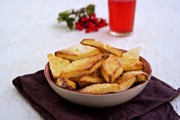 Homemade cottage cheese biscuits in a clay bowl on a light background concrete. Baking with cottage cheese.