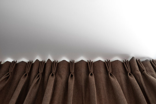 Brown Curtains On A Rail With A White Ceiling. Curtain Interior Decoration In Living Or Sleeping Room. Comfortable Live In Your Own Home. Sweet Confy Home.