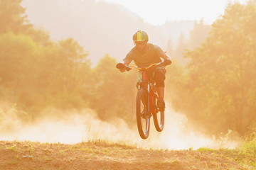 Man riding mountain bike dowhnill forest dirt trail