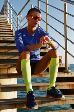 Sportswoman checking fitness tracker on steps