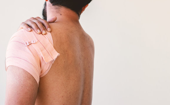 man shoulder with crepe  bandage for recovery of muscle recovery 