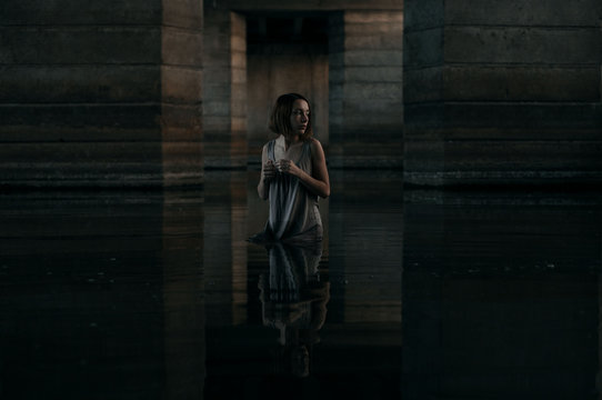 girl at water under bridge