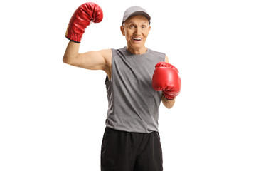 Elderly man with boxing gloves showing muscles