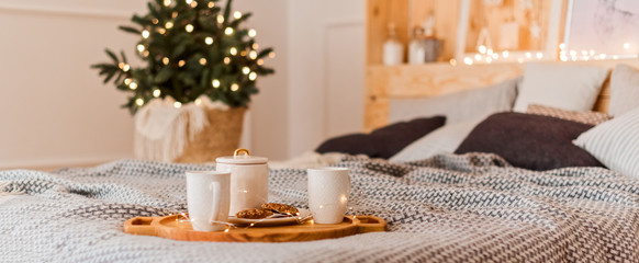 Christmas hot drink with cookie on the bed