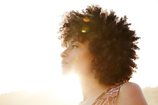 Portrait of African American woman backlit by the sun at the beach