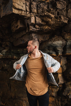 Portrait of a Stylish Young Man Adjusting His Jacket