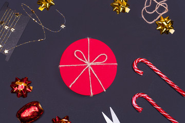 Red round gift box on black background, new year and Christmas gift wrapping