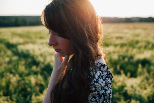 Woman in field at sunset