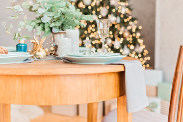 Christmas wooden table, a glass of champagne, table setting