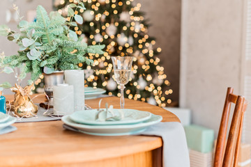Christmas table, a glass of champagne, table setting